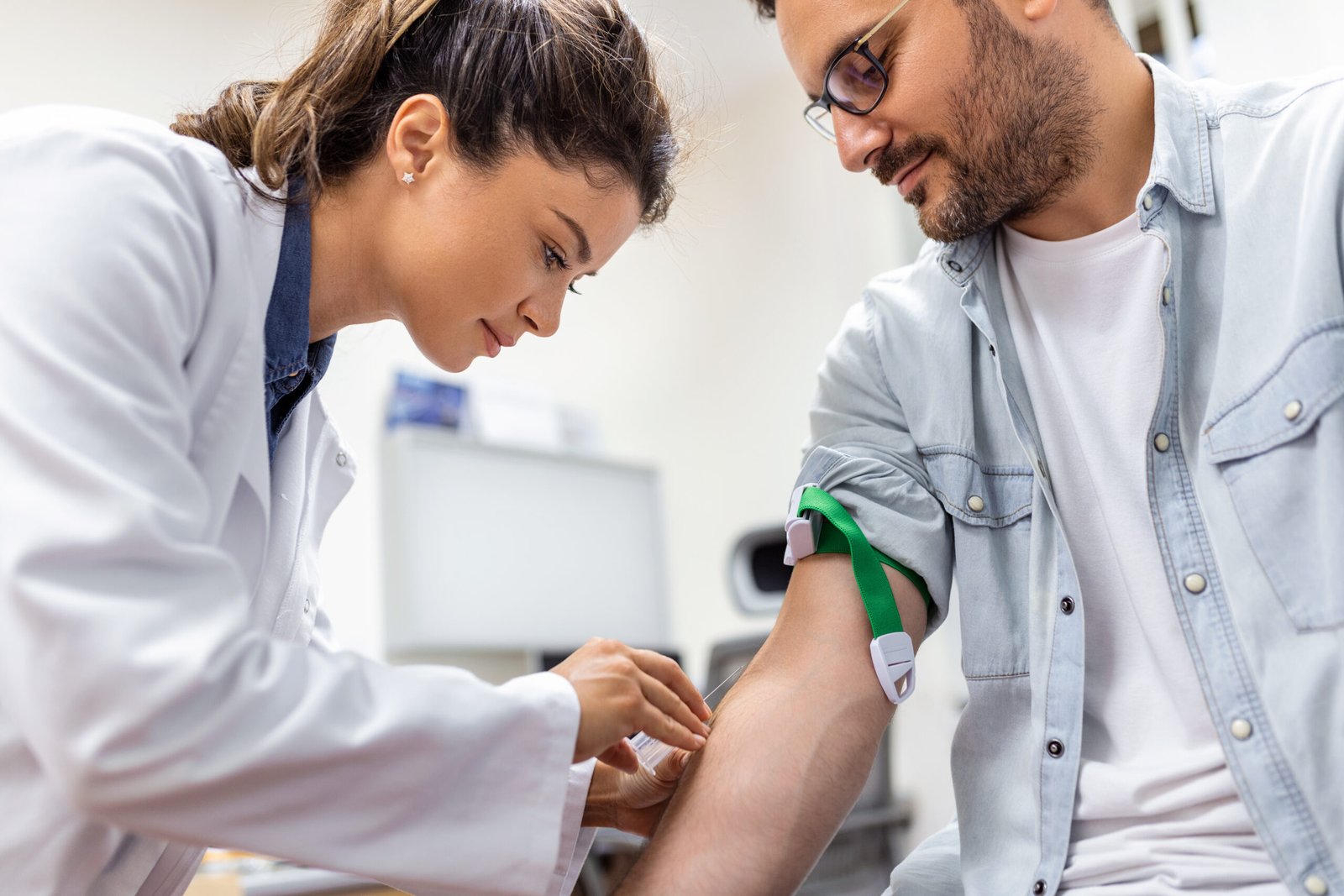 Phlebotomist collecting a blood sample from a patient in a Cyprus laboratory