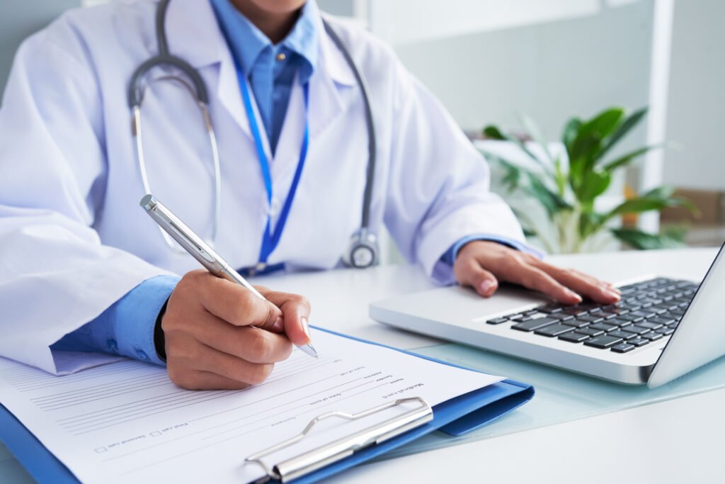 Doctor using a computer to search for GESY providers in Cyprus